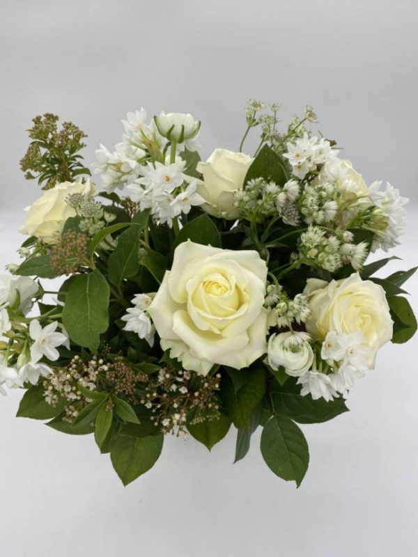 a bouquet including white roses and other mixed white flowers