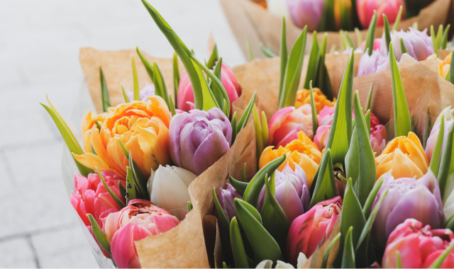 colourful bouquets in brown paper outside